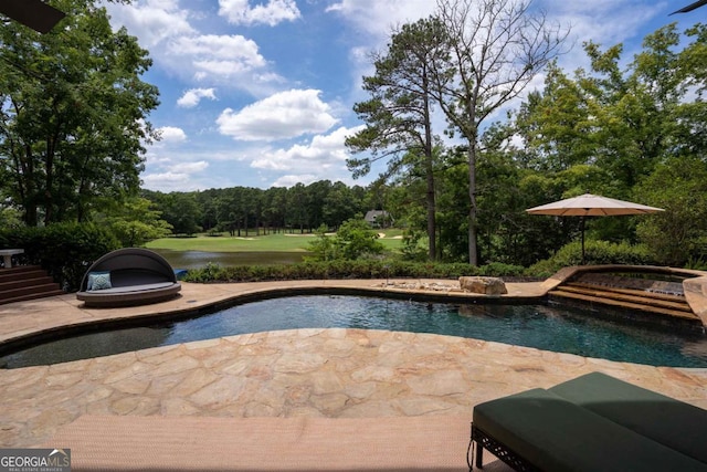 pool with a jacuzzi and a patio