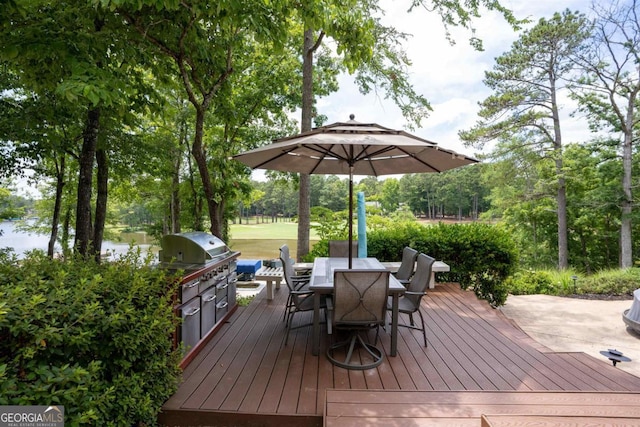 deck with outdoor dining area and area for grilling