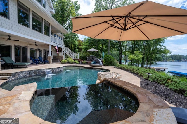 pool with stairway, a patio area, a water view, and ceiling fan