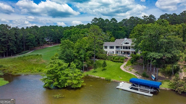 drone / aerial view with a view of trees and a water view