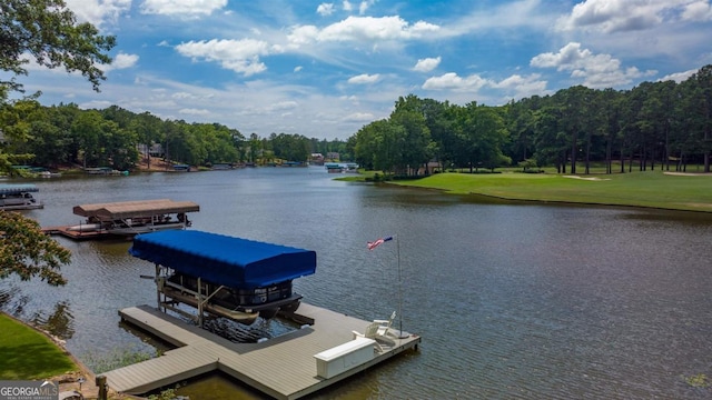 view of dock with a lawn, a water view, and boat lift