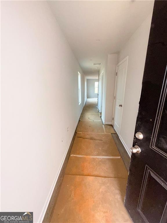 hallway featuring baseboards