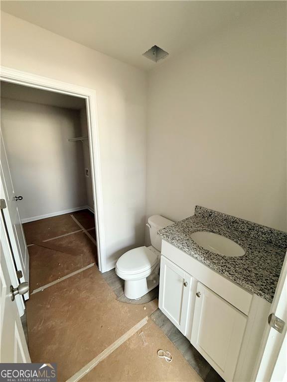 half bath with vanity and toilet