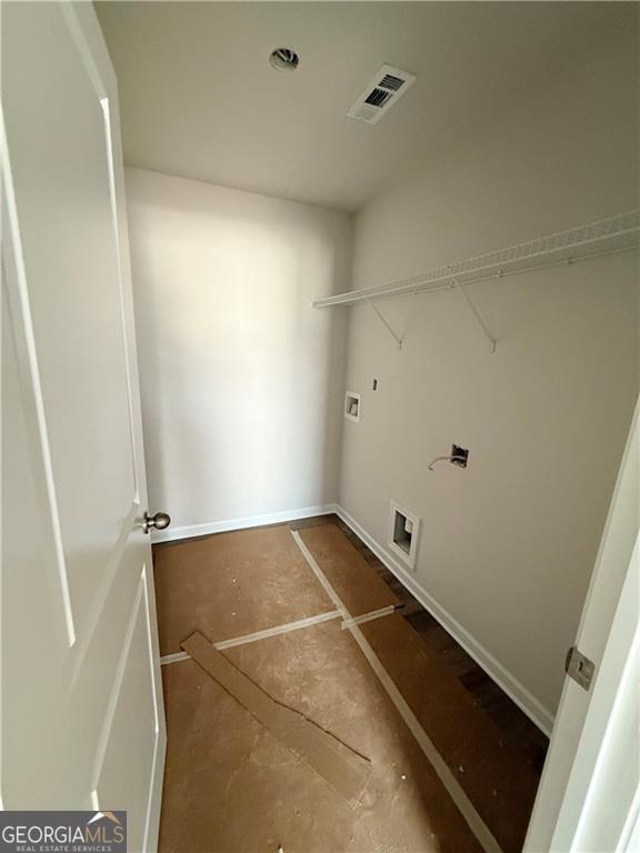 laundry room with laundry area, hookup for a washing machine, and visible vents