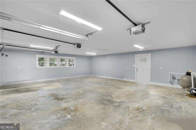 garage with baseboards and a garage door opener