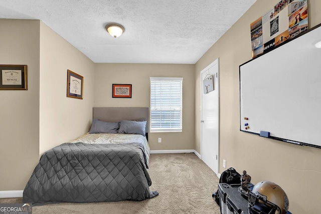 carpeted bedroom featuring baseboards and a textured ceiling