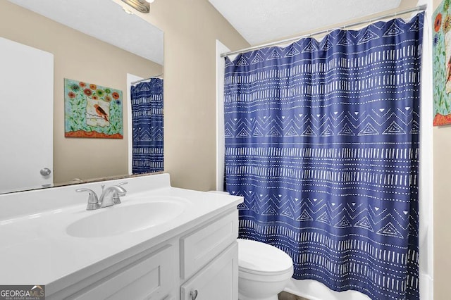 bathroom featuring a shower with shower curtain, toilet, and vanity