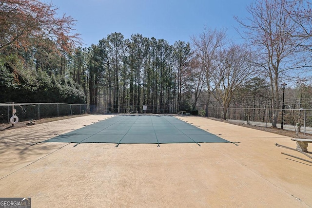 view of swimming pool with a patio area, a fenced in pool, and fence