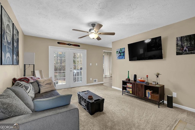 living area with french doors, baseboards, ceiling fan, and carpet floors