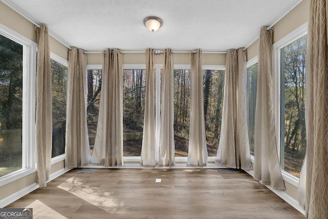 unfurnished sunroom with visible vents