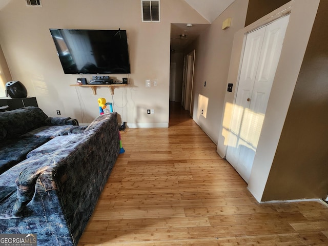6160 Great Oaks Dr, Lithonia, GA 30058 - living room with vaulted ceiling, visible vents, and light wood-type flooring