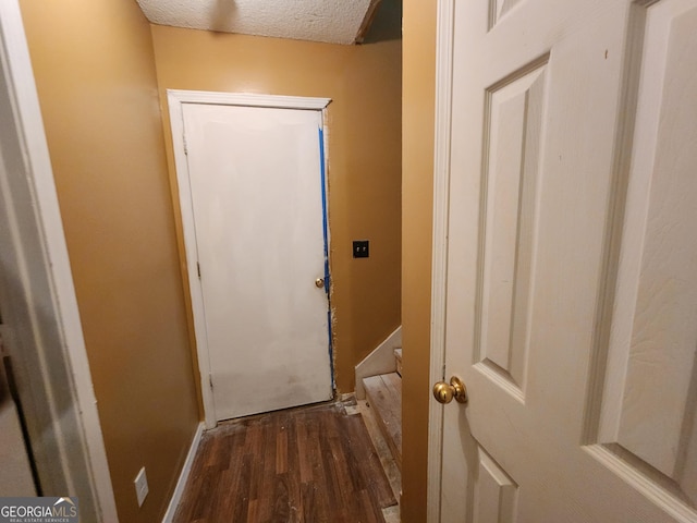 6160 Great Oaks Dr, Lithonia, GA 30058 - doorway to outside featuring a textured ceiling, baseboards, and wood finished floors