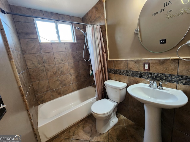 6160 Great Oaks Dr, Lithonia, GA 30058 - full bath featuring a wainscoted wall, toilet, a sink, tile walls, and shower / tub combo