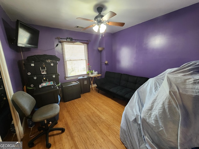 6160 Great Oaks Dr, Lithonia, GA 30058 - living room featuring light wood finished floors, visible vents, and a ceiling fan