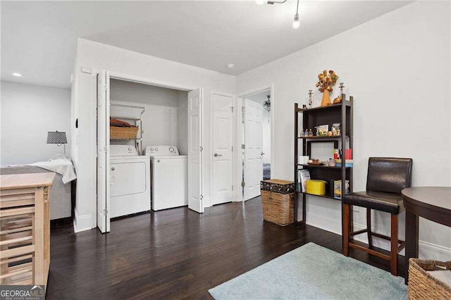 interior space featuring laundry area, wood finished floors, washing machine and dryer, and recessed lighting