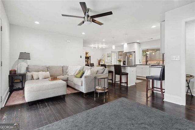 living room featuring recessed lighting, baseboards, ceiling fan, and dark wood-style flooring