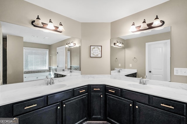 full bath with double vanity, a garden tub, and a sink