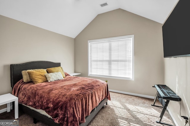 carpeted bedroom featuring visible vents, baseboards, and vaulted ceiling