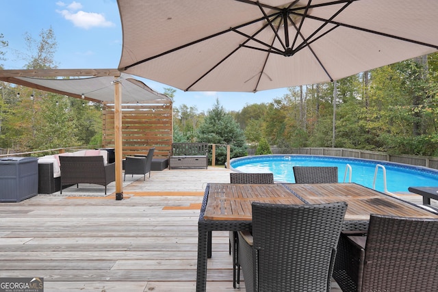 view of pool with a fenced in pool, fence, outdoor dining area, outdoor lounge area, and a deck