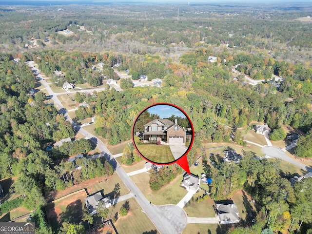 birds eye view of property featuring a view of trees