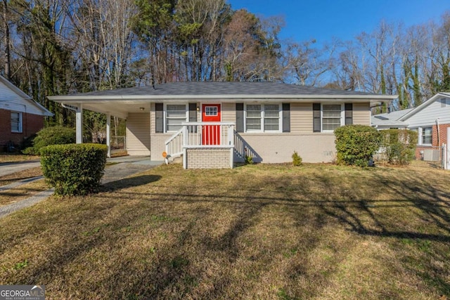 view of front of home featuring a carport, brick siding, a front yard, and crawl space