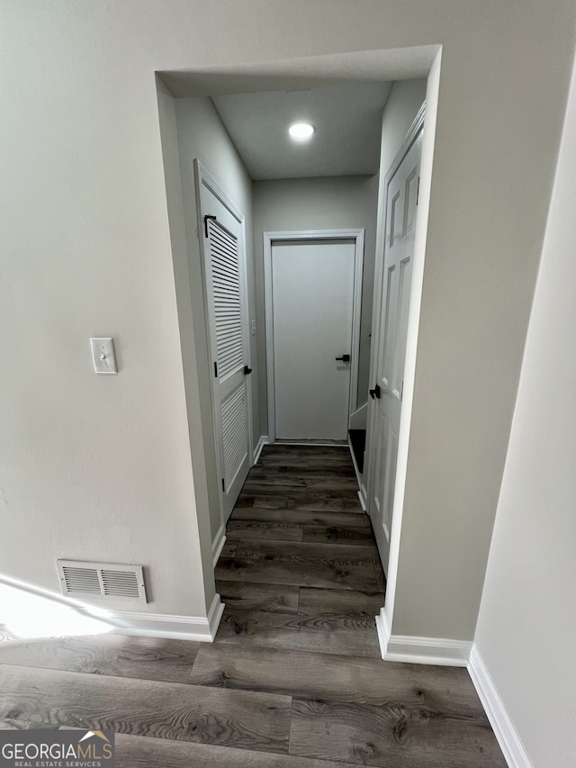 interior space featuring visible vents, baseboards, and wood finished floors