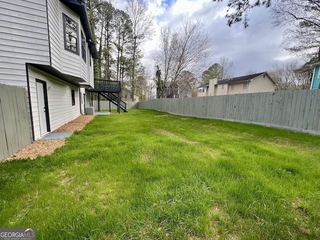 view of yard featuring stairway, cooling unit, and fence private yard