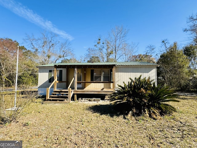 view of front facade featuring metal roof and covered porch