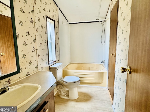 full bath featuring tub / shower combination, wallpapered walls, toilet, wood finished floors, and vanity