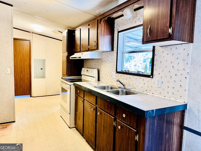 kitchen featuring wallpapered walls, under cabinet range hood, electric panel, white electric range oven, and a sink