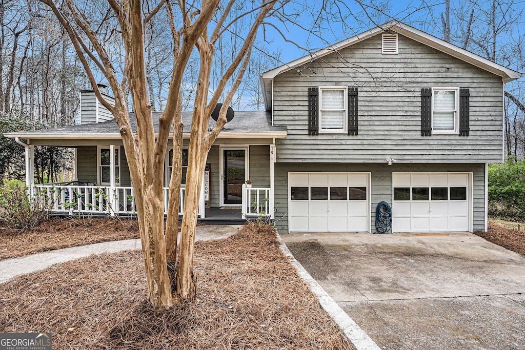 79 Mountain View Ct, Dallas, GA 30157 - tri-level home with an attached garage, a chimney, concrete driveway, a shingled roof, and a porch