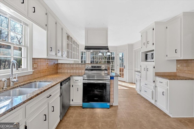 kitchen with a sink, white cabinets, tasteful backsplash, and stainless steel appliances