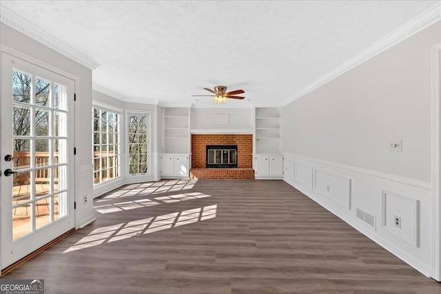 unfurnished sunroom with visible vents, a brick fireplace, and ceiling fan