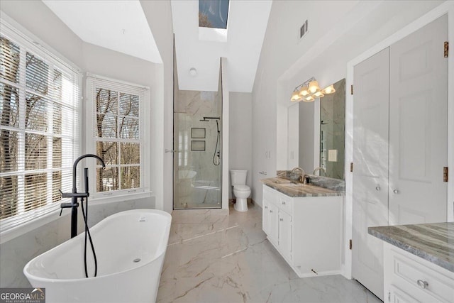 full bath featuring visible vents, a shower stall, a freestanding bath, marble finish floor, and vanity