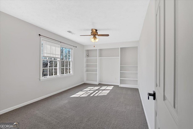 unfurnished bedroom featuring baseboards, carpet floors, and a textured ceiling