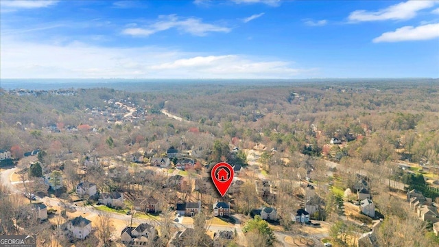 drone / aerial view featuring a wooded view