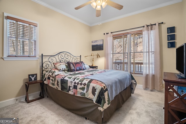 carpeted bedroom featuring ceiling fan, baseboards, and ornamental molding