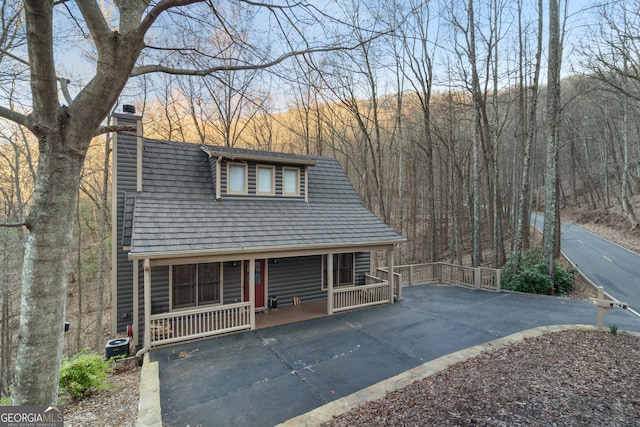 view of front of property with a porch and a chimney