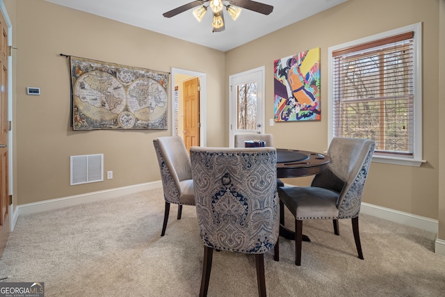 dining room with visible vents, baseboards, and carpet