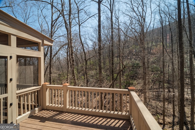 wooden deck featuring a view of trees