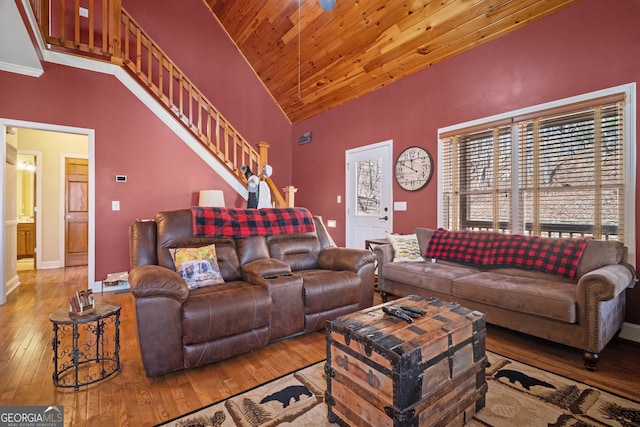 living area with baseboards, stairway, wood ceiling, high vaulted ceiling, and wood-type flooring