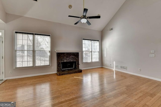 unfurnished living room with visible vents, wood-type flooring, and ceiling fan