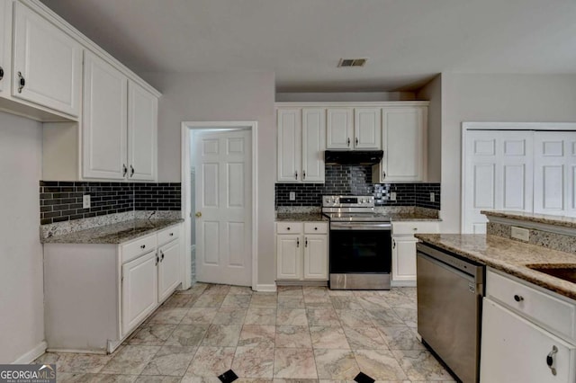 kitchen featuring light stone counters, visible vents, white cabinets, under cabinet range hood, and appliances with stainless steel finishes