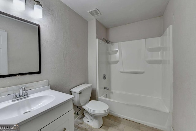 full bath featuring vanity, visible vents, shower / tub combination, toilet, and a textured wall