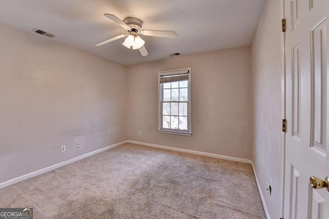 unfurnished room with carpet flooring, baseboards, visible vents, and ceiling fan