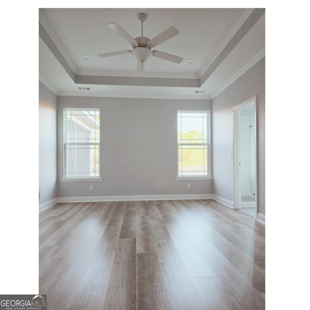 115 John Eady Ct, Savannah, GA 31405 - empty room with light wood-type flooring, a tray ceiling, ornamental molding, and ceiling fan