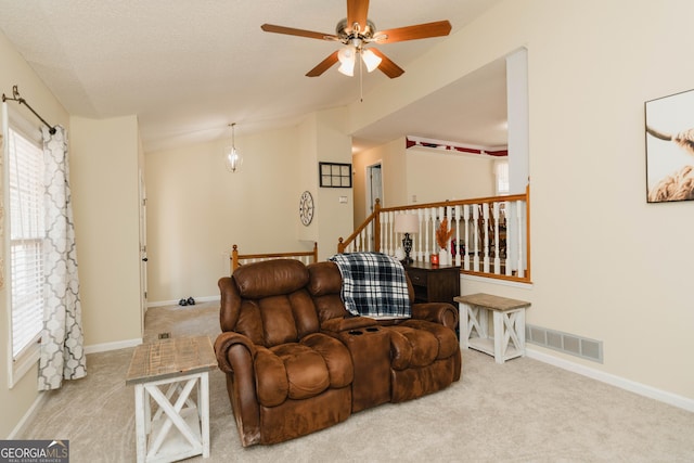 living area with visible vents, carpet flooring, lofted ceiling, and a ceiling fan