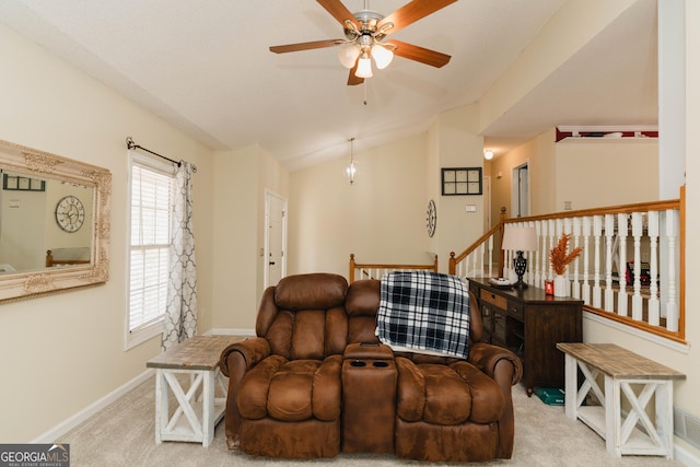 carpeted living area featuring baseboards, a ceiling fan, and vaulted ceiling