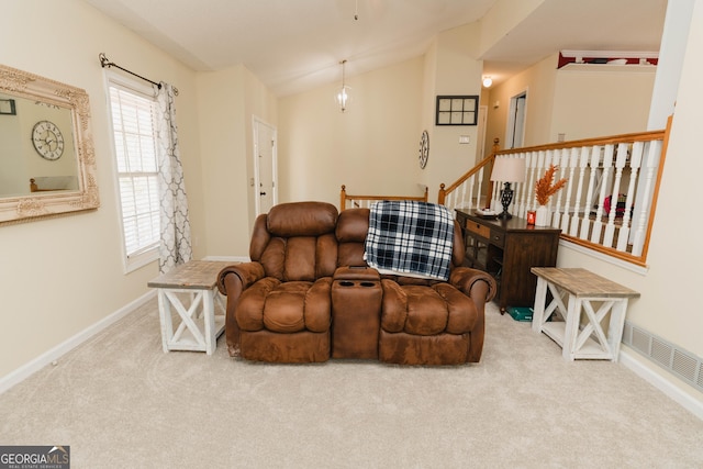 living room featuring vaulted ceiling, visible vents, baseboards, and carpet floors