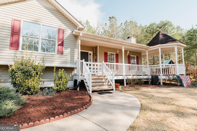 view of front of home with a porch and a chimney